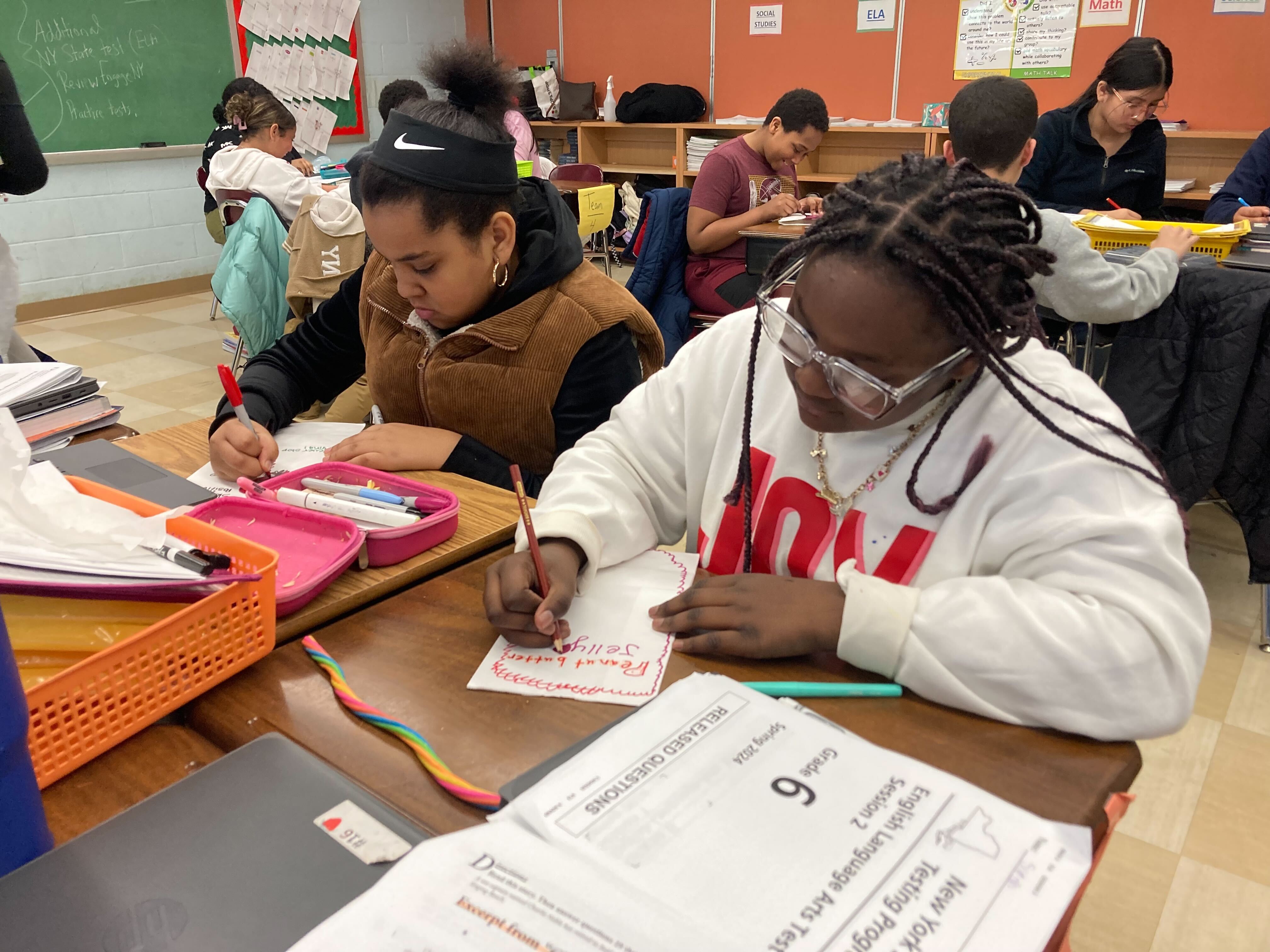 Students decorate meal bags together