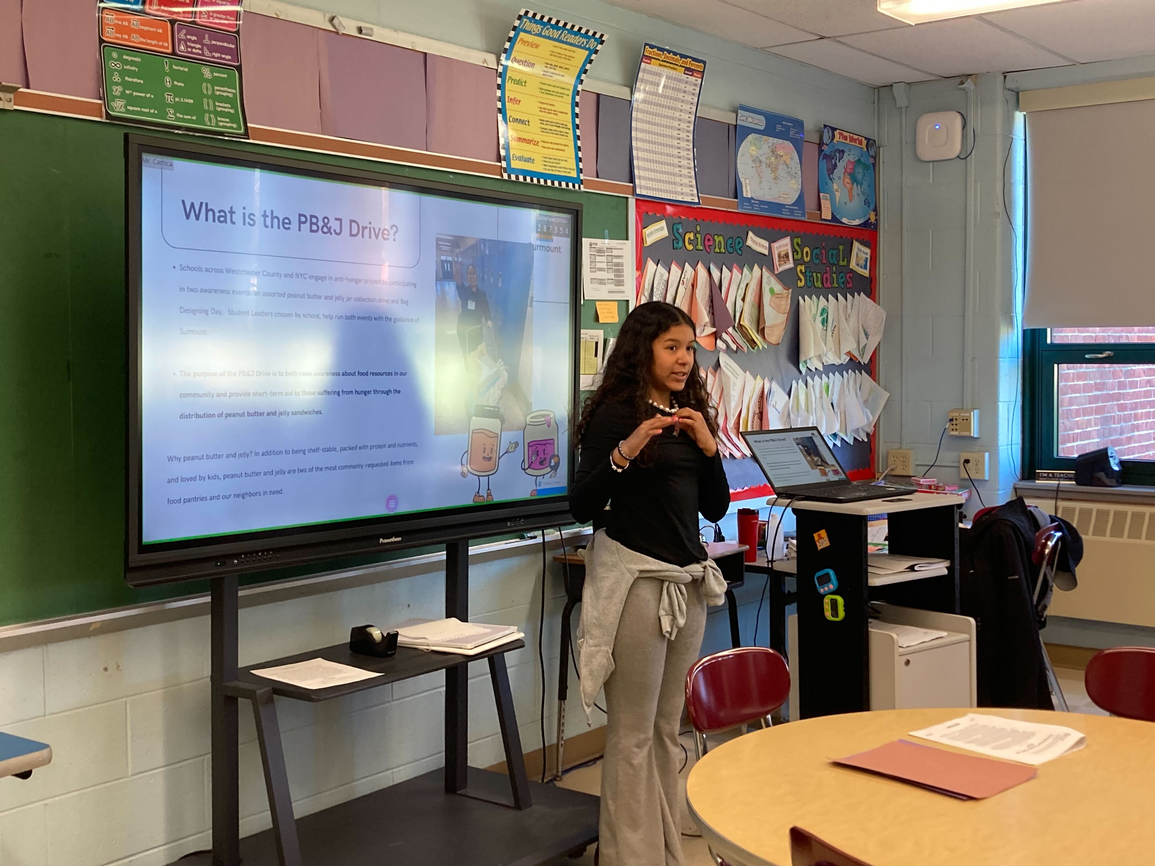 A student leads a classroom presentation about PB and J Drive
